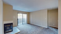 Located at 5675 Jacquiline Way in Livermore, California, this single-floor residence offers a well-organized layout designed for comfortable everyday living. The open living area is anchored by soft carpeting and features a sliding glass door with vertical blinds that opens to an outdoor space, filling the room with natural light. A fireplace serves as a focal point in the main living area, adding warmth and character. Adjacent to the living space, the kitchen is equipped with white cabinetry, a white electric range, a stainless steel sink with ample counter space, and light hardwood-style flooring, providing a clean and functional workspace. A ceiling fan enhances comfort in the shared living and dining area. The bedrooms are carpeted and well-proportioned, each featuring windows that bring in natural light and views of the surrounding neighborhood. The primary bedroom benefits from a walk-in closet, offering generous storage. The bathroom is finished with light hardwood-style flooring, white cabinetry, a single-sink vanity with a large mirror, and bright overhead lighting. Throughout the home, neutral warm-toned walls and clean white trim create a bright, cohesive aesthetic that is move-in ready.