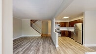 Located at 510 Cain Ct in Belle Mead, NJ, this multi-level townhome spans three floors and offers a well-organized layout with 2 bedrooms, 1 bathroom, a finished basement, and a balcony. Light-toned wood-style flooring flows throughout the main living areas, complemented by neutral warm-beige walls and crown molding that add a clean, polished feel.

The main level features an open-concept living and dining area filled with natural light from large windows overlooking greenery, along with a dedicated entrance. The kitchen is outfitted with rich dark-wood cabinetry, granite countertops with a white tile backsplash, and a full suite of stainless steel appliances including a gas range, microwave, and dishwasher.

The full bathroom is finished with a granite-topped vanity, dark wood cabinetry, wood-look tile flooring, and both a glass-enclosed shower and a shower-tub combination. The bedrooms feature plush carpeting and generous closet space, with the primary bedroom offering ample room and a window with outdoor views. Additional storage is provided through multiple closets throughout the home. The finished basement adds valuable flexible space, while the balcony offers an outdoor retreat. A staircase connects all three levels seamlessly.