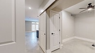 Located at 503 Avenue A in San Antonio, Texas, this contemporary 2-bedroom, 2-bathroom residence delivers a well-designed single-story layout with thoughtful finishes throughout. Polished concrete floors run seamlessly across the entire space, lending an industrial-modern aesthetic that ties each room together cohesively.

The kitchen is a standout feature, showcasing bold navy shaker cabinetry accented with gold hardware, a large central island with a white quartz countertop and undermount sink, stainless steel appliances including a double wall oven and French door refrigerator, and sleek pendant lighting overhead. A dedicated pantry provides additional storage. The open-plan living area adjoins the kitchen and is bathed in natural light from French doors with transom windows above, which lead out to a private balcony. A ceiling fan completes the comfortable living space.

The primary bedroom is generously sized, featuring a ceiling fan and access to its en-suite bathroom, which is appointed with white cabinetry, gold fixtures, and a glass-enclosed walk-in shower with tile surround. The second bedroom includes a closet with louvered doors and its own ceiling fan. The second bathroom mirrors the refined design with white vanity cabinetry and black hardware accents. Multiple closets and two hallways ensure ample storage and easy circulation throughout.