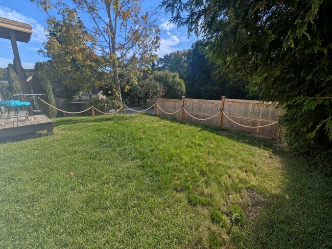 Private side entrance with full backyard and deck with bistro - 1689 Main St