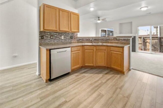 kitchen with dishwasher and bar - 14700 E 104th Ave