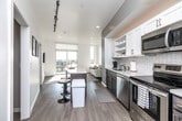 Located at 335 Cedar St in Waterloo, IA, this modern 2-bedroom, 1-bathroom unit offers a thoughtfully designed open-concept layout with contemporary finishes throughout. Light wood-style flooring and a neutral color palette create a clean, cohesive aesthetic across the living spaces.

The kitchen is a standout feature, equipped with stainless steel appliances including a refrigerator, range, microwave, and dishwasher. White shaker-style upper cabinets with open shelving contrast elegantly against darker lower cabinetry, while a white quartz countertop and subway tile backsplash complete the polished look. A kitchen island with bar seating provides additional prep and dining space.

The living room is bright and airy, bathed in natural light from floor-to-ceiling sliding glass doors that open onto a private balcony with expansive city views — a defining feature of the space.

The primary bedroom offers a comfortable retreat with a stylish barn door leading to a dedicated walk-in closet with built-in shelving. The second bedroom is equally well-appointed with its own closet access.

The bathroom features a combination tub and shower, a vanity with wood-toned cabinetry, white countertop, and large mirror, all finished with tile flooring for a clean, functional design.