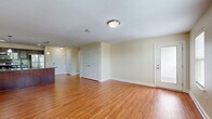 Located at 60 Weibel Ave in Saratoga Springs, NY, this single-floor, one-bedroom, one-bathroom residence offers a comfortable and efficiently designed living space. The open-concept kitchen and living area is anchored by warm hardwood flooring that flows throughout, creating a cohesive and inviting atmosphere. The kitchen is a standout feature, boasting rich dark wood cabinetry, granite countertops, a center island with a built-in sink, stainless steel appliances including a refrigerator, range, and microwave, and stylish pendant lighting overhead. The living area is bright and airy, benefiting from multiple windows with blinds that allow natural light to fill the room. The bedroom is a comfortable retreat, finished with plush carpeting, a large double-door closet, and a window overlooking the outdoors. The bathroom features a full soaking tub and shower combo with clean white surround panels and tile flooring. A private entry door opens to an outdoor area, adding convenience and accessibility. Neutral wall tones and clean white trim throughout give the space a fresh, move-in-ready feel.