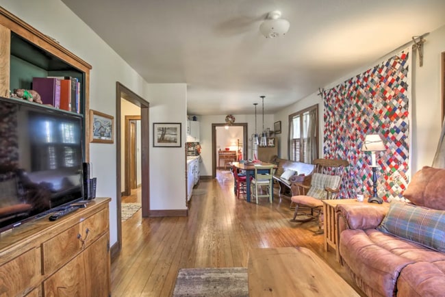 Living room view into kitchen and dining area, smart tv, leather sofa, open floor plan - 65 Old Flowers Rd