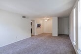 Located at 4000 Forest Creek Lane in West Deptford, NJ, this single-floor, two-bedroom, one-bathroom home offers a practical and comfortable layout. The living area is bright and open, featuring wall-to-wall carpeting and multiple tall, narrow windows that allow abundant natural light to fill the space with an airy, welcoming atmosphere.

The kitchen is efficiently designed with dark cabinetry, light stone-style countertops, stainless steel appliances including a refrigerator and electric range, a built-in microwave, and light wood-style flooring. The galley-style layout makes excellent use of the available space.

The primary bedroom is generously sized, boasting a walk-in closet with built-in shelving and two windows offering views of the surrounding greenery. The second bedroom is comfortably sized with its own pair of tall windows, plush carpeting, and a bright, neutral finish. A hallway and dedicated closet provide additional storage throughout.

The full bathroom is clean and functional, featuring a combination tub and shower, a dark wood vanity with a light countertop, wood-style flooring, and a louvered closet door for added storage. Neutral white walls and consistent finishes throughout the home create a cohesive, move-in-ready aesthetic.
