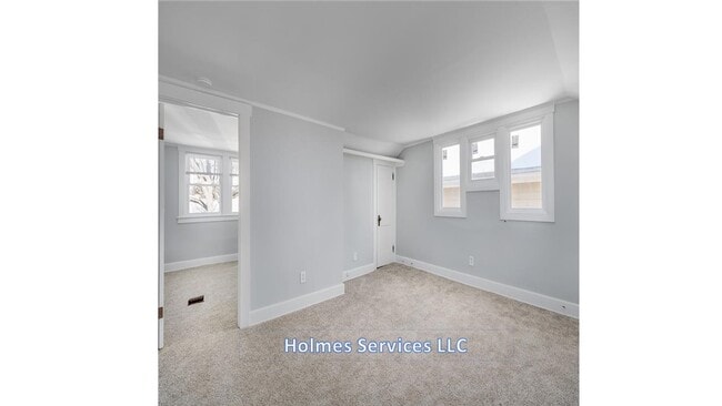 Living room (vacant) - door to bedroom on left and door to 1 (of 2) walk in closets on right. - 1226 Bird Ave