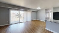 Located at 5042 Silver Hill Ct in District Heights, Maryland, this single-floor residence has been thoughtfully updated with modern finishes throughout. The open living area features warm luxury vinyl plank flooring and large sliding glass doors dressed with sheer vertical blinds, inviting an abundance of natural light while providing access to an outdoor area with views of the surrounding neighborhood. The neutral gray walls create a clean, contemporary palette that complements the space seamlessly.

The kitchen is well-appointed with crisp white shaker-style cabinetry, granite countertops, and a full suite of black appliances, including a gas range, refrigerator, and dishwasher. The layout offers ample counter and storage space, making it highly functional for everyday use.

The bedrooms are carpeted in a warm neutral tone and feature generous closet space, including both walk-in and reach-in configurations. Large windows and sliding glass doors in several bedrooms allow for excellent natural light and outdoor views.

The bathrooms are finished with striking marble-style tile surrounds. One bathroom features a soaking tub with a tiled surround, while another offers a walk-in shower with a glass enclosure, both paired with dark vanity cabinetry and granite countertops for an elegant, cohesive look throughout.