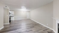 Located at 3130 Saint Anthony Gardens Dr in Louisville, KY, this single-floor, 2-bedroom, 2-bathroom home offers a well-designed layout with modern finishes throughout. Durable hardwood-style plank flooring runs continuously across all living areas, lending warmth and cohesion to the space.

The open living room is bright and airy, highlighted by a stylish chandelier and neutral toned walls that complement the light flooring. It flows seamlessly into the kitchen, which features white shaker cabinetry, granite countertops with a subway tile backsplash, a deep double sink, and a full suite of stainless steel appliances including a refrigerator, electric range, and microwave. A decorative pendant light adds a contemporary touch overhead.

Both bedrooms are comfortably sized with neutral walls and natural light from windows overlooking the surrounding greenery. The primary bedroom features an elegant chandelier, while the second bedroom includes curtain rods already in place.

The two bathrooms are clean and functional, each featuring granite-topped vanities, modern fixtures, and coordinating tile flooring. One bathroom includes a full soaking tub with shower combo.

A hallway connects the private areas of the home. Sliding doors lead to a spacious wooden deck overlooking a lush, tree-lined backyard — an ideal outdoor retreat.