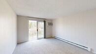 Located at 567 Sagamore Ave in Portsmouth, NH, this 2-bedroom, 1-bathroom residence offers a well-organized single-floor layout designed for comfortable everyday living. The bright living room features soft carpeting, a wall-mounted AC unit, baseboard heating, and a sliding glass door that opens to a private balcony overlooking lush greenery, filling the space with natural light and outdoor views. The updated kitchen is outfitted with white shaker cabinets, dark countertops, a white subway tile backsplash, stainless steel appliances including a refrigerator, range, microwave, and dishwasher, and tile flooring, with a ceiling fan adding comfort overhead. Both bedrooms are carpeted and offer a calm, neutral palette with ample natural light from large windows. The primary bedroom is generously sized and includes a dedicated closet with built-in shelving. The second bedroom also features closet space. The full bathroom presents a classic aesthetic with black-and-white octagon tile flooring, a white tub-shower combination, and a vanity with mirror. This residence provides a clean, functional home base in a well-situated Portsmouth location.
