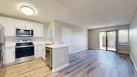 Located at 502-514 E Barham Dr in San Marcos, California, this single-floor unit offers a clean, modern aesthetic throughout. The open-concept living and dining area is bathed in natural light, with light wood-style luxury vinyl plank flooring extending seamlessly through the entire space. A sliding glass door leads to a private outdoor patio, creating an easy indoor-outdoor connection.

The kitchen is thoughtfully designed with crisp white shaker-style cabinetry extending to the ceiling for maximum storage, a white quartz countertop, and a full suite of stainless steel appliances including a refrigerator, range, microwave, and dishwasher. A peninsula counter separates the kitchen from the living area, making it ideal for both cooking and entertaining. A ceiling fan adds comfort to the main living space.

The bedroom features a mirrored sliding-door closet and a bright window with exterior views, complemented by the same luxury vinyl plank flooring. The bathroom is finished with a white shaker-style vanity, white countertop, updated fixtures, and a well-lit mirror, all set against neutral tones that carry throughout the unit. Textured ceilings and crisp white trim complete the refined, move-in-ready interior.