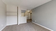 Located at 470 Maxey Rd in Houston, TX, this single-floor unit offers three bedrooms and three bathrooms within a compact, efficiently designed layout. The living room features plush carpeting and neutral-toned walls, opening toward a kitchen with a raised bar-style counter that separates it from the combined dining area. The kitchen is equipped with wood-style plank flooring that extends into the hallways and bathrooms, providing a cohesive look throughout the common areas. Each bedroom is carpeted and bathed in natural light through window blinds, with the primary bedroom offering a walk-in closet fitted with dual shelving rods and a dedicated vanity area complete with a granite-style countertop, under-sink cabinetry, and a large mirror with overhead lighting. Additional bedrooms include closet space with built-in shelving. The three bathrooms are clean and functional, featuring light-toned cabinetry and bright vanity fixtures. A dedicated laundry area and a balcony add to the unit's practicality. Textured ceilings and soft neutral color palettes are consistent throughout, creating a calm and livable atmosphere well-suited for everyday comfort.