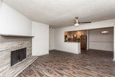 This single-floor residence in Atlanta, GA (30318) offers a well-designed open-concept layout that seamlessly connects the living, dining, and kitchen areas. Rich hardwood-style flooring runs throughout the main living spaces, complemented by ceiling fans that add both function and visual interest. The kitchen is a standout feature, outfitted with white shaker-style cabinetry, granite countertops, a gray subway tile backsplash, under-cabinet lighting, and a full suite of stainless steel appliances including a gas range, microwave, dishwasher, and refrigerator. A peninsula counter with a granite top provides additional workspace and separates the kitchen from the living area. The dining and living spaces benefit from an open, airy feel with clean white walls and recessed lighting. Bedrooms are finished with plush wall-to-wall carpeting and feature large windows that allow natural light to fill each room. The bathrooms are well-appointed; one includes a walk-in shower with floor-to-ceiling tile surround, a granite-topped vanity with shaker cabinets, and wood-look tile flooring, while a second bathroom offers a clean, functional layout. Overall, the space presents a cohesive, modern aesthetic throughout.