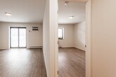 Located at 240 Prospect Ave in Hackensack, NJ, this 2-bedroom, 1-bathroom unit offers a well-organized single-floor layout with thoughtfully updated finishes throughout. The living area features wood-look laminate flooring, crisp white walls, and a textured ceiling, with a large sliding window that allows natural light to fill the space. A wall-mounted air conditioning unit and baseboard heating provide year-round climate control.

The kitchen is efficiently designed with gray shaker-style cabinetry, white countertops, a stainless steel sink, and a full suite of stainless steel appliances including a refrigerator, electric range, and dishwasher — offering both style and function in a compact galley layout.

The primary bedroom is a comfortable size, featuring the same laminate flooring and a sliding double-door closet with built-in rods and shelving for organized storage. The second bedroom is similarly appointed and benefits from natural light via its own window.

The bathroom stands out with elegant marble-style floor-to-ceiling tile, a soaking tub with overhead shower, a white vanity, and chrome fixtures, creating a clean and refined aesthetic. A hallway connects the rooms, completing this practical and attractively finished unit.