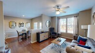 Located at 11400 Space Center Blvd in Houston, TX, this thoughtfully designed one-bedroom, one-bathroom residence offers a comfortable and functional single-floor layout. Rich hardwood flooring flows through the open-concept living, dining, and kitchen areas, creating a cohesive and inviting atmosphere. The living room features large windows that flood the space with natural light, a ceiling fan, and ample room for seating. It connects seamlessly to a defined dining area, which includes a charming window view and decorative wall accents. The kitchen is well-equipped with dark espresso cabinetry, granite-style countertops, stainless steel appliances including a side-by-side refrigerator, electric range, and microwave, plus a breakfast bar with seating. A dedicated pantry adds valuable storage. The spacious primary bedroom offers plush carpeting, a ceiling fan, natural light from a window, and access to two closets. The full bathroom features tile flooring, a dark vanity with granite countertops, and a shower-tub combination. Additional conveniences include an in-unit laundry area and a hallway connecting all rooms. The warm, neutral color palette and modern finishes throughout give this residence a polished, move-in-ready feel.