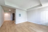 Located at 220 Redpath Ave in Toronto's vibrant Midtown neighbourhood, this efficiently designed unit offers a thoughtful open-concept layout that maximizes every inch of its intimate footprint. Light hardwood flooring runs throughout, lending warmth and visual continuity across the space.

The kitchen is outfitted with rich dark-wood cabinetry, granite countertops with a white tile backsplash, and a full suite of stainless steel appliances — including a refrigerator, electric range, built-in microwave, and dishwasher. The galley-style arrangement keeps everything within easy reach while flowing naturally into the open living area.

The living space is bright and airy, anchored by expansive floor-to-ceiling sliding glass doors that invite an abundance of natural light and provide direct access to a balcony with open city views. The clean white walls and tray ceiling detailing contribute to a modern, uncluttered aesthetic.

A separate bedroom area features its own window with urban views, a sliding-door closet, and the same warm hardwood flooring, maintaining a cohesive feel throughout.

The bathroom is finished in crisp white tile, featuring a single-sink vanity with under-cabinet storage, a large mirror, and a full soaker tub with shower. The overall ambiance of the unit is clean, contemporary, and move-in ready.