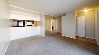 Located at 4801 S Braden Ave in Tulsa, Oklahoma, this one-bedroom, one-bathroom unit offers a practical and comfortable single-floor layout. The open-concept living and kitchen area forms the heart of the space, with the kitchen featuring dark cabinetry, light speckled countertops, a stainless steel sink, a black refrigerator, and a dishwasher — all set on light wood-style flooring. A breakfast bar peninsula separates the kitchen from the carpeted living room, which is bathed in natural light through a large sliding glass door fitted with vertical blinds that opens to an outdoor view. The textured ceilings add a classic touch throughout the main living area. The bedroom is a well-proportioned retreat with plush carpet, a window overlooking the exterior, and direct access to a dedicated walk-in closet, providing generous storage. A hallway connects the main areas to the full bathroom, which includes a single-sink vanity with speckled countertops, dark cabinetry, light wood-style flooring, and a full tub/shower combination. The thoughtful layout maximizes the use of space while maintaining a clean, functional flow throughout.