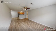 Located at 700 Woodland Heights Dr in Sanford, NC, this single-story, 3-bedroom, 1-bathroom home offers a well-organized layout with practical living spaces throughout. The open-concept kitchen and dining area serves as the heart of the home, featuring warm honey-toned cabinetry, stainless steel appliances including a refrigerator, range, and over-the-range microwave, light-toned countertops, and a peninsula with a sink that provides additional workspace and casual seating. Light hardwood-style flooring flows throughout the main living areas, adding warmth and continuity. The living room is generously proportioned, bathed in natural light from large windows, and finished with a ceiling fan overhead. A hallway connects the bedrooms, each equipped with ceiling fans and closets. The spacious primary bedroom features plush carpeting and direct access to the bathroom. The secondary bedrooms also offer carpet flooring, ceiling fans, and windows that bring in natural light. A dedicated laundry area adds everyday convenience. Throughout the home, neutral gray tones, clean white trim, and consistent finishes create a cohesive and move-in-ready atmosphere well-suited for comfortable living.