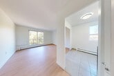 Located at 735 Wonderland Rd S in London, Ontario, this one-bedroom, one-bathroom unit offers a thoughtfully designed layout that makes efficient use of its space. The entrance opens into a clean, tile-floored hallway with flush ceiling lighting, providing a welcoming transition into the main living areas.

The living room is bright and open, featuring light hardwood-style flooring and a large window that frames views of the surrounding mature trees, filling the space with generous natural light. Baseboard heating runs along the perimeter, ensuring year-round comfort. The kitchen features tile flooring, a window overlooking the greenery outside, and includes a stainless steel refrigerator.

The bedroom is a well-proportioned retreat with the same warm hardwood-style flooring, a window with outdoor views, and a built-in closet with sleek, modern panel doors. Additional closet storage is available throughout the unit, with three closets in total providing ample organization space.

A private balcony extends the living space outdoors, offering a relaxing vantage point overlooking a tree-lined setting with vibrant seasonal foliage — ideal for enjoying morning coffee or fresh air.

The unit's clean white walls and consistent finishes throughout create a bright, neutral aesthetic that is easy to personalize. The overall layout is practical and comfortable, suited for single occupants or couples seeking a functional home in a natural setting.