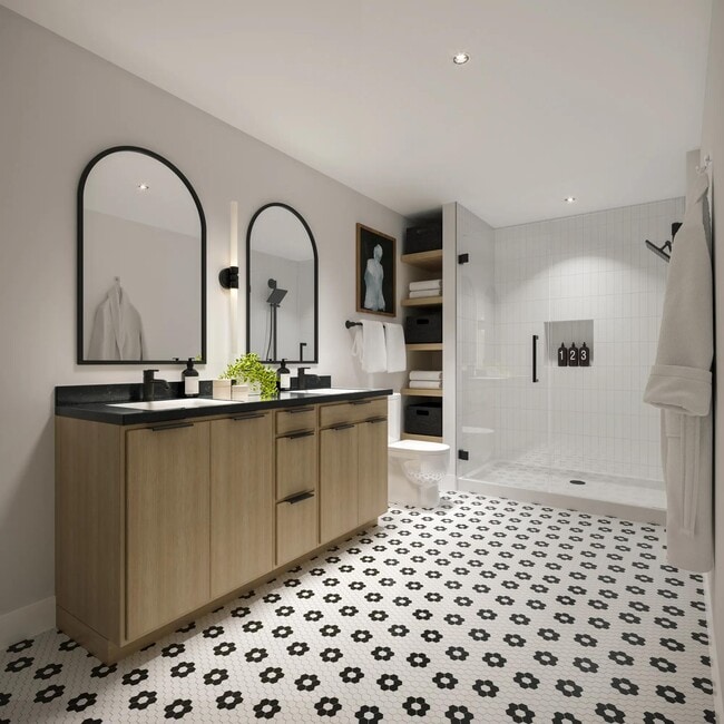 Select apartment homes at Modera Nations feature frameless glass showers with floor-to-ceiling tile surrounds. - Modera Nations