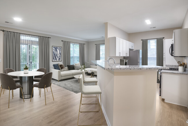 Renovated Package II kitchen and living room with hard surface flooring - Avalon at Traville