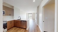 This contemporary 570 square foot apartment offers a thoughtful blend of style and functionality. The open-concept living area seamlessly integrates the kitchen and living room, creating a spacious feel enhanced by warm wood-look flooring throughout. The kitchen boasts modern wood-grain cabinetry, stainless steel appliances, and a subway tile backsplash, perfect for culinary enthusiasts. The generously sized 130 square foot bedroom provides ample space for relaxation and includes a closet for storage. The bathroom features a modern vanity and a shower/tub combination. A private balcony accessible from the living area offers outdoor space and natural light. The apartment's neutral color palette and clean lines create a versatile canvas for personal style. With its efficient layout and modern amenities, this one-bedroom unit in Delancey at Shirlington Village presents an ideal living space for urban professionals or couples seeking a contemporary lifestyle.