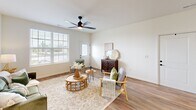 Located at 100 Bricks Hill Rd in O'Fallon, Missouri, this well-appointed one-bedroom, two-bathroom residence offers a thoughtfully designed single-floor layout with a dedicated office, two closets, and a seamless flow throughout. The bright, open living room welcomes natural light through large windows and features warm wood-look flooring, neutral walls, and a ceiling fan — creating an inviting, relaxed atmosphere. The kitchen is a standout, showcasing crisp white shaker cabinetry, granite countertops, a center island with bar seating, stainless steel appliances including a refrigerator, range, microwave, and dishwasher, and recessed lighting overhead. The spacious primary bedroom is a serene retreat with a ceiling fan, natural light from a well-positioned window, and access to a generously sized walk-in closet outfitted with wire shelving for ample storage. The bathrooms are clean and functional, with one featuring a full tub and shower combination. The dedicated office provides a quiet, light-filled workspace with its own ceiling fan and window view. Wood-look flooring runs consistently through the main areas, tying the space together with a cohesive, modern aesthetic suited for comfortable everyday living.
