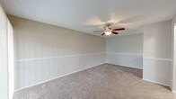 Located at 4500 Baymeadows Rd in Jacksonville, FL, this two-bedroom, one-bathroom unit offers a well-organized single-floor layout designed to maximize functionality. The galley-style kitchen is a standout feature, boasting granite countertops, crisp white cabinetry, stainless steel appliances including a refrigerator and range, a undermount sink with a matte black faucet, and light wood-look flooring that adds a clean, modern feel. Additional cabinet storage and counter space provide practical utility throughout. Both bedrooms are carpeted and feature ceiling fans with light fixtures, neutral-toned walls, and windows with blinds that allow for natural light. The primary bedroom offers a generous footprint, while the second bedroom provides comfortable accommodations. A dedicated closet adds valuable storage to the layout. The full bathroom includes a granite-topped vanity, a mirror, and a tiled shower-tub combination, maintaining the consistent, updated aesthetic found throughout the unit. A carpeted hallway connects the rooms seamlessly, with transitions to the kitchen's hard-surface flooring. Textured ceilings are present throughout, complementing the neutral color palette that gives the entire space a clean, move-in-ready appearance.