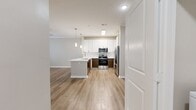 This 1200 square foot apartment in Charleston, SC, offers a harmonious blend of modern amenities and thoughtful design. The single-floor layout features one bedroom spanning 160 square feet, complemented by two full bathrooms for added convenience. The kitchen stands out with its contemporary appeal, boasting white upper cabinets contrasted by warm wood lower cabinets, stainless steel appliances, and a sleek countertop with a modern sink and faucet.

Throughout the apartment, you'll find a mix of flooring options. The bedroom and closet are carpeted for comfort, while the kitchen and main living areas showcase attractive wood-look flooring. The bathrooms feature easy-to-maintain tile flooring. Large windows with blinds allow for ample natural light and privacy control.

Storage is a strong point in this unit, with a dedicated closet featuring wire shelving systems. The hallways provide smooth transitions between rooms, contributing to the apartment's flow. Neutral wall colors throughout create a canvas for personal styling. Modern lighting fixtures and recessed lighting add to the contemporary ambiance. This well-designed space efficiently utilizes its 1200 square feet to offer comfortable, stylish living in Charleston's desirable 29492 zip code.