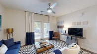 Located at 120 Buckhill Village Dr in Burlington, NC, this thoughtfully designed single-floor residence offers 2 bedrooms and 2 bathrooms across a comfortable and functional layout. Rich hardwood-style flooring flows through the main living areas, complemented by neutral tones and clean white trim throughout.

The open-concept kitchen and dining area is a standout feature, showcasing white cabinetry, granite countertops, stainless steel appliances, and a peninsula island with pendant lighting and bar seating — ideal for both everyday meals and entertaining. A pantry provides additional storage convenience.

The living room is bright and welcoming, with a ceiling fan, large windows, and glass French doors that open directly onto a private patio with outdoor views. Both bedrooms are carpeted and generously sized, each equipped with ceiling fans. The spacious primary bedroom benefits from ample natural light and access to a large walk-in closet with wire shelving. The two bathrooms are clean and functional, featuring tub/shower combinations with wood-style flooring.

A dedicated in-unit laundry room with side-by-side washer and dryer adds everyday convenience. With seven closets total throughout the home, storage is plentiful. The entrance and hallway provide a smooth transition between all areas of this well-organized residence.