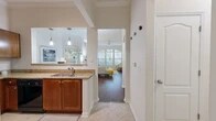 Located at 2373 SW Archer Rd in Gainesville, FL, this well-appointed 2-bedroom, 2-bathroom single-floor residence offers a thoughtful layout designed for comfortable everyday living. The inviting living room is a standout feature, boasting soaring ceilings, crown molding, a ceiling fan, and a striking set of arched windows that flood the space with natural light and views of the surrounding greenery. Rich hardwood-style flooring runs throughout the main living areas, adding warmth and continuity.

The kitchen is well-equipped with warm-toned cabinetry, granite countertops, black appliances, a tile backsplash, and a double-basin sink set into a peninsula that opens to the dining area via a pass-through, enhanced by stylish pendant lighting. The primary bedroom is generously sized with high ceilings, hardwood-style flooring, and access to a spacious walk-in closet with wire shelving. The second bedroom is bright and welcoming, featuring large windows with outdoor views. Both bathrooms are finished with granite vanities and matching cabinetry. A dedicated in-unit laundry room with a full-size washer and dryer adds everyday convenience, rounding out this functional and attractive Gainesville home.