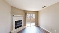 Located at 7566 Greenback Ln in Citrus Heights, CA, this one-bedroom, one-bathroom unit offers a well-organized single-floor layout with a comfortable and functional design throughout.

The combined kitchen and living area serves as the heart of the unit. The living room features warm, hardwood-style plank flooring, neutral beige walls, and a standout tile-surround fireplace with a classic white mantle, providing a cozy focal point. The kitchen is thoughtfully designed in a galley configuration, showcasing white cabinetry, granite-style countertops, a stainless steel sink, and white appliances including a range and refrigerator. A window above the sink brings in natural light, enhancing the clean and bright aesthetic.

The bedroom is a generously sized private retreat finished with plush carpet flooring and a large window fitted with blinds that allow for ample natural light. A dedicated closet provides practical storage. The bedroom connects conveniently to the rest of the unit through a private doorway.

The bathroom continues the consistent neutral palette with hardwood-style flooring, a white vanity with a light countertop, and a grab bar for added accessibility and safety.

Throughout the unit, warm beige tones, clean white trim, and durable flooring choices create a cohesive, inviting ambiance that is both practical and comfortable.