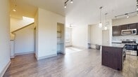 This contemporary apartment at The Flats at Palisades offers a thoughtfully designed living space across two floors, totaling 1240 square feet. The layout comprises 2 bedrooms, 3 bathrooms, and additional functional areas including a hallway and two closets. The primary bedroom, at 160 square feet, provides ample space for comfort and relaxation.

The interior showcases a neutral color palette with crisp white walls, creating a bright and airy atmosphere throughout. Large windows in the bedrooms and living areas allow natural light to flood the space, while also offering pleasant outdoor views. The flooring varies between plush carpeting in the bedrooms and sleek hardwood in the main living areas, adding texture and warmth to the overall design.

The open-plan living area seamlessly integrates the kitchen, featuring dark wood cabinetry that contrasts beautifully with the light-toned flooring. Modern pendant lighting and track lights enhance the contemporary feel of the space. The bathrooms are fitted with high-quality fixtures, including a combination of shower-over-tub and walk-in shower options, along with granite countertops in some.

Storage solutions are well-considered, with built-in closets and shelving units providing ample space for organization. The apartment's two-story layout, connected by a staircase, offers a sense of separation between living and sleeping areas, enhancing the overall functionality of the home.