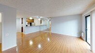 Located at 1538 N Vista St in Los Angeles, CA 90046, this single-floor unit offers a well-designed layout that balances functionality and comfort. The open living area is a standout feature, showcasing warm hardwood flooring that runs throughout and a full-wall mirror that amplifies the sense of space and light. A ceiling fan adds practicality, while a sliding glass door leads to a private balcony, bringing in natural light and outdoor views of the surrounding neighborhood.

The kitchen is efficiently arranged and thoughtfully finished, featuring rich dark-stained wood cabinetry, granite countertops, a black gas range, and a stainless steel refrigerator. Tile backsplash and tile flooring complete the space, while a pass-through counter connects the kitchen to the living area, enhancing the open feel. The layout also includes a convenient entry area with hardwood flooring that flows seamlessly into the main living space.

The bathroom is clean and well-equipped, offering a white vanity with granite countertops, a large wall mirror with overhead lighting, tile flooring, and a shower-tub combination with a glass sliding door. A closet with a hanging rod provides additional storage within the unit. The textured ceiling is consistent throughout, lending a cohesive finish to the interior.