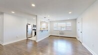 Located at 130 New Rd in Parsippany, NJ, this thoughtfully updated one-bedroom, one-bathroom unit offers a clean, modern aesthetic with quality finishes throughout. Rich hardwood flooring extends across the open-concept living room and into the bedroom, creating a warm and cohesive feel. The living area is bright and airy, benefiting from natural light through large windows and recessed lighting overhead.

The kitchen is a standout feature, designed with crisp white cabinetry, a herringbone tile backsplash, light tile flooring, and a full suite of stainless steel appliances including a refrigerator, gas range, built-in microwave, and dishwasher. A pass-through counter with pendant lighting connects the kitchen to the living area, enhancing the open flow of the space.

The bedroom is a comfortable, well-proportioned room with a large double closet, hardwood floors, a natural light source from a window, and baseboard heating. The bathroom is tastefully renovated with white cabinetry, a quartz countertop, a tub-shower combo featuring chevron mosaic tile accents, and sleek matte black hardware. Recessed lighting and a backlit mirror complete the refined look of this well-appointed home.