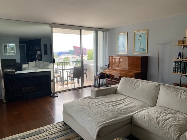 Living room with fireplace and balcony - 8530 Holloway Dr