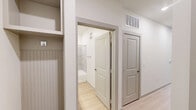 This well-designed one-bedroom, one-bathroom unit at 8025 Monty Stratton Pkwy in Greenville, TX offers a smart, efficient layout across a single floor. The open kitchen is a standout feature, showcasing gray shaker-style cabinetry, granite countertops, a subway tile backsplash, and a full suite of stainless steel appliances including a range, built-in microwave, and dishwasher — all set atop light hardwood-style flooring.

The living area connects seamlessly to the bedroom, which is carpeted for comfort and features a ceiling fan, neutral walls, and a walk-in closet with built-in shelving and hanging rods for organized storage. A hallway with an electrical panel provides added convenience.

The bathroom is thoughtfully appointed with granite countertops, gray shaker-style vanity cabinets, a large mirror, wall-mounted lighting, and a tiled tub-shower combination — all complemented by light wood-style flooring for a clean, cohesive look.

Natural light is a defining characteristic of this unit, with a trio of large windows fitted with horizontal blinds offering views of the surrounding community. The overall aesthetic is modern and neutral, creating a bright and welcoming atmosphere throughout.