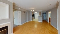 Located on the 9th floor at 1221 24th St NW in Washington, DC's desirable West End neighborhood, this residence offers a thoughtfully designed single-floor layout. The open living area features warm hardwood flooring, crown molding, a textured ceiling, and a fireplace as a central focal point. Large windows allow natural light to fill the space, offering views of the surrounding cityscape. The living area flows seamlessly into the kitchen, which is equipped with granite countertops, warm honey-toned wood cabinetry, black appliances including a refrigerator, electric range, microwave, and dishwasher, along with a skylight that brightens the workspace. A peninsula counter connects the kitchen to the main living area. The bedrooms are carpeted and receive ample natural light through sizable windows fitted with blinds. Two bathrooms serve the residence; one features a combined tub and shower with tile surround, while the other offers a walk-in shower. Both bathrooms include wood vanity cabinetry, large mirrors, and tile flooring. The unit's neutral color palette and functional layout make it a versatile and comfortable home in one of Washington, DC's most accessible urban neighborhoods.
