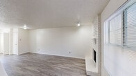 Located at 2156 Cranford in Garland, TX, this two-story home offers a practical and well-organized layout across two floors. The main level features a bright, open living room with wood-look laminate flooring, a textured ceiling, and a standout white-painted brick fireplace that serves as the room's focal point. Natural light filters in through a front-facing window, adding warmth to the space. The kitchen is efficiently designed with tan cabinetry, laminate countertops, a peninsula breakfast bar, and includes a refrigerator and electric range. A separate back door provides convenient outdoor access to a fenced exterior area. Upstairs, two carpeted bedrooms offer a quieter retreat. The generously sized primary bedroom includes a closet with a bifold door and connects to its own bathroom. The second bedroom features a ceiling fan with light fixture and a window that brings in natural light. Both bathrooms are clean and functional, with tub-shower combinations. A dedicated closet provides additional storage. Throughout the home, textured ceilings and neutral white walls create a clean, move-in-ready aesthetic. The staircase connects both levels seamlessly, making this a cohesive and functional two-story residence.