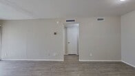 This 510 square foot apartment in Dallas, TX offers a well-designed living space on a single floor. The property features one bedroom measuring 140 square feet, providing a comfortable sleeping area. The layout includes a hallway, one bathroom, a closet for storage, a kitchen, and a living room, efficiently utilizing the available space.

The interior showcases modern finishes throughout. The living area boasts gray wood-look flooring, creating a contemporary aesthetic. Large sliding glass doors flood the space with natural light and offer potential outdoor views. The kitchen, while compact, features white cabinetry and speckled countertops, providing a clean and functional cooking space.

The bathroom is updated with large, neutral-toned tiles and a white bathtub, offering a fresh and clean appearance. The bedroom continues the modern theme with the same flooring as the living area and is equipped with a ceiling fan for comfort.

The apartment's neutral color palette, predominantly in shades of white and light gray, creates a bright and airy atmosphere throughout. This color scheme also allows for easy personalization with decor. The overall design focuses on maximizing the efficiency of the compact space, making it an ideal option for singles or couples seeking a modern, low-maintenance living environment in Dallas.
