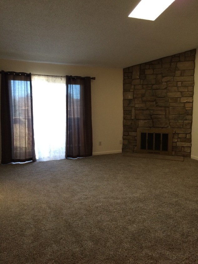 Living room, stone fireplace, vaulted ceiling - 203 Wright St