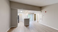 Located at 765 Polk Drive in Arlington, TX, this two-bedroom, two-bathroom residence offers a well-designed single-floor layout with a cohesive neutral color palette throughout. The open-concept kitchen is a standout feature, boasting white shaker cabinetry, a subway tile backsplash, light stone countertops, stainless steel appliances, pendant lighting, and a skylight that fills the space with natural light. A breakfast bar connects the kitchen to the main living and dining areas, creating an inviting flow. The living room is highlighted by light wood-style flooring and a classic fireplace with a white mantel, providing a warm focal point. Both bedrooms are carpeted for comfort — the primary bedroom offers a well-sized layout, while the secondary bedroom features a built-in window seat with views of greenery and a sliding closet. Both bathrooms are equipped with tub-shower combinations finished in neutral tile surrounds. Throughout the residence, warm gray walls, white trim, and consistent flooring choices create a clean, unified aesthetic. Sliding glass doors in the living area allow for natural light and outdoor access, enhancing the overall sense of openness in this thoughtfully laid-out Arlington home.