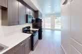 Located at 2709 Santa Maria Way in Santa Maria, California, this efficiently designed studio unit offers a well-planned single-floor layout that maximizes every square foot. The open-concept living area is bathed in natural light, courtesy of large windows with horizontal blinds that frame street views and keep the space feeling airy and bright. Light hardwood-style flooring runs throughout, lending a clean, contemporary look to the entire unit.

The kitchen is a standout feature, boasting rich, dark wood cabinetry extending from floor to ceiling for generous storage. Crisp white countertops provide a striking contrast, while black appliances — including a full-size refrigerator, electric range, and built-in microwave — offer a cohesive, modern aesthetic. The galley-style layout ensures an efficient workflow, making the most of the available space.

The bathroom is finished in clean, neutral tones and includes a full tub-and-shower combination with brushed nickel fixtures, offering both functionality and comfort.

The living area is open and versatile, with neutral walls and large windows that invite abundant natural light. A wall-mounted heating unit ensures year-round comfort. The overall ambiance is modern, clean, and move-in ready — ideal for those seeking a functional and stylish space in Santa Maria.
