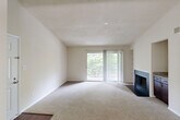 Located at 18832 Bent Willow Cir in Germantown, MD, this 2-bedroom, 2-bathroom home offers a well-designed single-floor layout with a comfortable and functional living experience. The spacious living room is a standout feature, boasting vaulted ceilings, plush carpeting, a wood-burning fireplace with a sleek dark surround, and built-in shelving. A sliding glass door opens to a private balcony overlooking lush, wooded scenery, filling the room with natural light. The kitchen is equipped with dark espresso cabinetry, granite countertops, stainless steel appliances, and hardwood-style flooring. A pass-through counter connects the kitchen to the living area, enhancing the open feel. A dedicated pantry closet provides ample storage. Both bathrooms feature granite-topped dark vanities and hardwood-style flooring, with one including a shower/tub combination. The primary bedroom offers generous proportions with natural light from a large window. The second bedroom is bright and carpeted, with its own window and convenient access to an exterior door. Two closets throughout the home provide additional storage. Neutral tones and clean finishes create a cohesive, move-in-ready ambiance throughout this Germantown residence.
