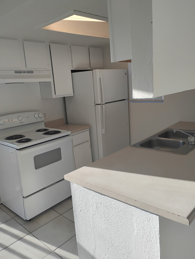 Kitchen with stove and Fridge. - 1007 Burkett St