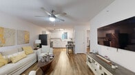 This well-designed two-bedroom, two-bathroom residence in Katy, TX offers a thoughtfully arranged single-floor layout that maximizes functionality and comfort. The living room greets you with warm wood-style flooring, a ceiling fan with integrated lighting, and natural light filtering through window treatments — creating an inviting, airy atmosphere. A stylish entryway with a paneled door transitions seamlessly into the main living area.

The kitchen is a standout feature, outfitted with crisp white cabinetry, light marble-style countertops, stainless steel appliances including a refrigerator, range, microwave, and dishwasher, plus track lighting overhead. Built-in open shelving adds additional storage and display space.

The primary bedroom offers a serene retreat with plush carpeting, a large window with blinds and drapes that allow ample natural light, and a cozy, restful ambiance. The second bedroom, also carpeted, features generous closet space and windows with sheer curtains. Both bathrooms are finished with wood-style flooring, single-sink vanities with marble-style countertops, and full tub-shower combinations, maintaining a clean, cohesive aesthetic throughout the home.