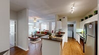 Located at 6111 N Beach St in Fort Worth, TX, this well-appointed two-bedroom, two-bathroom apartment offers a thoughtfully designed single-story layout. The open-concept living area seamlessly connects the kitchen, dining room, and living room, creating a spacious and cohesive flow throughout. The kitchen is equipped with stainless steel appliances, white cabinetry, dark granite-style countertops, and a peninsula with a double sink — ideal for both cooking and casual dining. Warm hardwood-style flooring runs through the main living areas, adding character and continuity. The dining room features crown molding, a large window for natural light, and a classic chair rail detail. The living room is bright and inviting, with a ceiling fan and additional windows that enhance the airy atmosphere. Both bedrooms are carpeted and feature distinctive tray ceilings with ceiling fans, large windows with natural light, and generous closet space with built-in shelving systems. The bathrooms are clean and functional, with tiled tub-shower combinations. A dedicated in-unit laundry area adds everyday convenience. The overall ambiance is bright, neutral, and move-in ready.