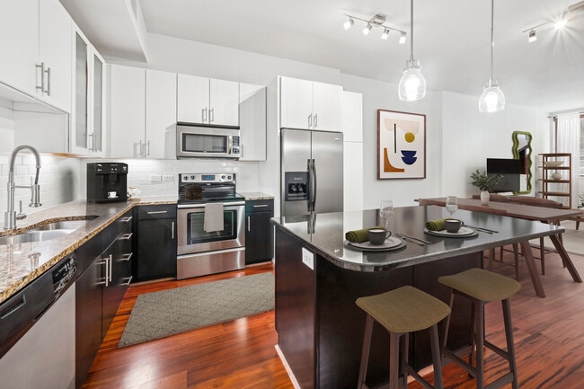 Experience modern elegance in every corner of this stylish kitchen and living space. - Arrive River Oaks