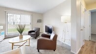 Located at 1505 Marion Rd SE in Rochester, Minnesota, this single-floor unit offers a well-organized layout designed for comfortable everyday living. The kitchen is a functional highlight, featuring rich dark wood cabinetry, granite-style countertops, stainless steel appliances including a refrigerator and dishwasher, and warm wood-look luxury vinyl plank flooring that extends into the entryway and dining area. A dedicated dining space sits adjacent to the kitchen, conveniently positioned near the entry door. The living room provides a relaxed atmosphere with plush carpeting, a wall-mounted air conditioning unit, baseboard heating, and a sliding door that invites natural light and outdoor views. Two carpeted bedrooms offer comfortable retreats, each featuring windows with blinds that allow for natural light, baseboard heating, and ceiling light fixtures. The full bathroom is well-appointed with warm wood cabinetry, granite-style countertops, open shelving, and a tub-shower combination, all complemented by wood-look vinyl plank flooring. Throughout the unit, neutral wall tones and clean finishes create a cohesive, move-in-ready aesthetic suited for a variety of residents.