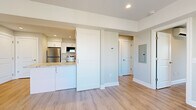 Located at 925 Mix Ave in Hamden, Connecticut, this thoughtfully designed 2-bedroom, 1-bathroom unit offers a clean, modern aesthetic across a well-utilized single floor. Light-toned hardwood flooring flows seamlessly throughout every room, creating a cohesive and warm atmosphere.

The kitchen is a standout feature, boasting crisp white shaker cabinetry, granite countertops with subtle veining, and a full suite of stainless steel appliances including a range, microwave, dishwasher, and refrigerator. A functional layout maximizes counter and storage space, making it both practical and visually appealing.

The spacious primary bedroom receives generous natural light through a large picture window with outdoor views of the surrounding neighborhood and greenery. A wall-mounted split HVAC unit provides efficient climate control. The second bedroom is comfortably sized with its own window and neutral tones throughout.

A central hallway connects the living areas to the bedrooms and bathroom, maintaining a logical and efficient flow. The bathroom features clean white finishes consistent with the overall design language of the home. Recessed lighting throughout the unit adds a polished touch, while soft gray walls complement the light flooring to create a bright, inviting living environment.