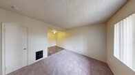 Located at 820 S E Street in Oxnard, California, this one-bedroom, one-bathroom unit offers a functional and efficient single-floor layout. The living room features soft carpeting, a textured popcorn ceiling, a ceiling fan, and a wall-mounted heater unit, creating a comfortable and practical space. Natural light filters in through a window fitted with vertical blinds, offering a view of the surrounding greenery. The entry area leads seamlessly into the living space, maintaining an open and accessible flow throughout the unit. The combined dining and kitchen area features hard-surface flooring, providing a practical contrast to the carpeted living and sleeping spaces. The bedroom is a well-proportioned room with plush carpet, neutral walls, a textured ceiling, and a window that brings in additional natural light. Two closets offer ample storage throughout the unit. The bathroom is clean and straightforward, equipped with a full-size soaking tub and shower combination featuring chrome fixtures. Throughout the unit, the warm beige tones on the walls and neutral finishes create a cohesive and understated aesthetic, making it easy to personalize the space.